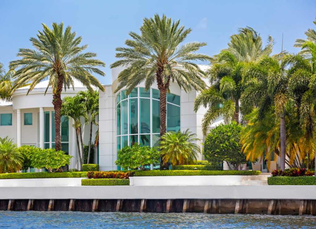 A coastal home on the water with palm trees